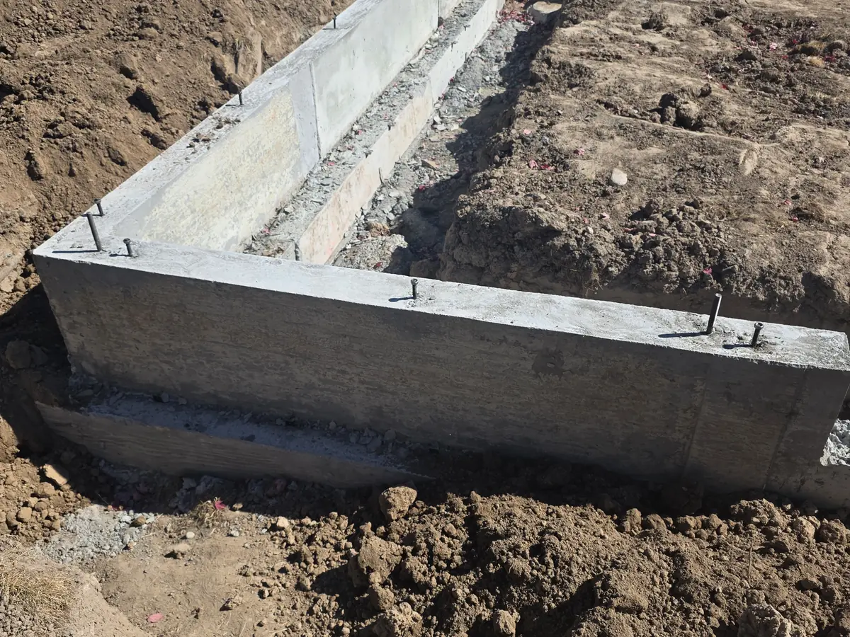 Stripped concrete stem wall ready for backfill at the Eagle custom home addition.