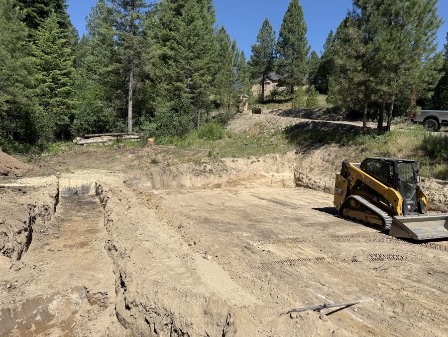 Deck pier and pad excavation progress for the Garden Valley Retreat project.